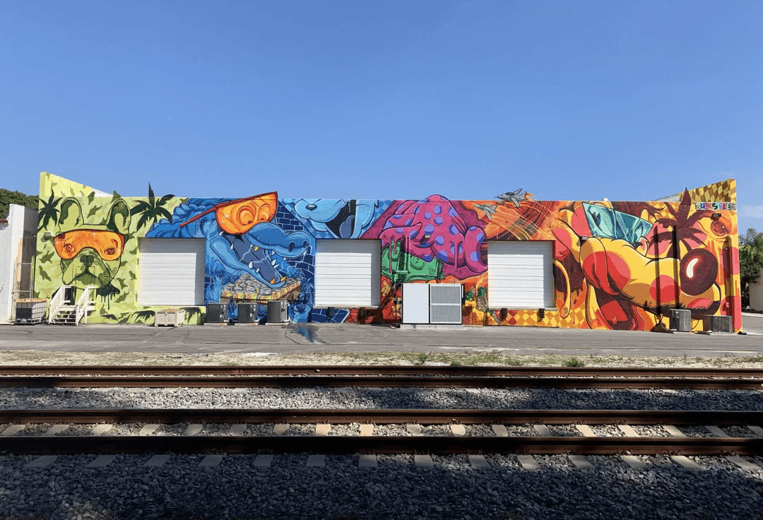 Bulk Styles building mural — street art facade with characters, jets, and BULK STYLES branding