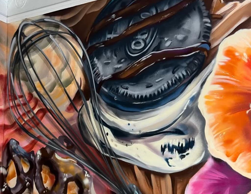 Detail of the Brittany's Cupcake Shoppe bakery mural featuring a whisk and dessert elements