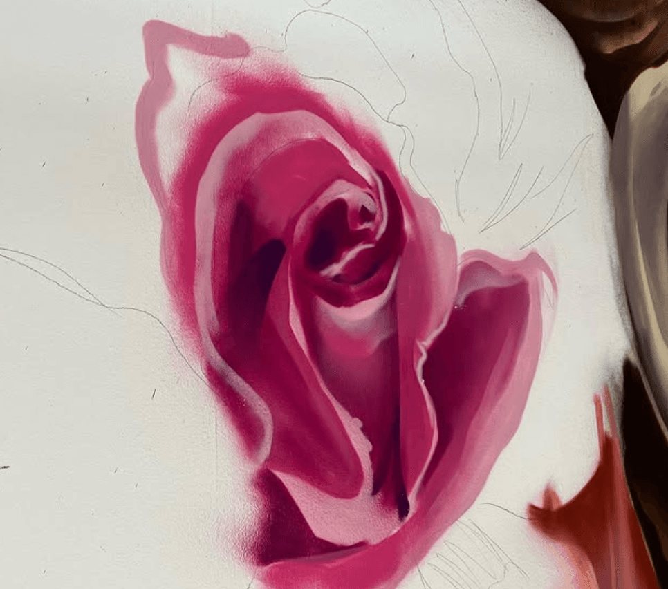 Close up of a pink rose being spray painted as part of the Brittany's Cupcake Shoppe mural