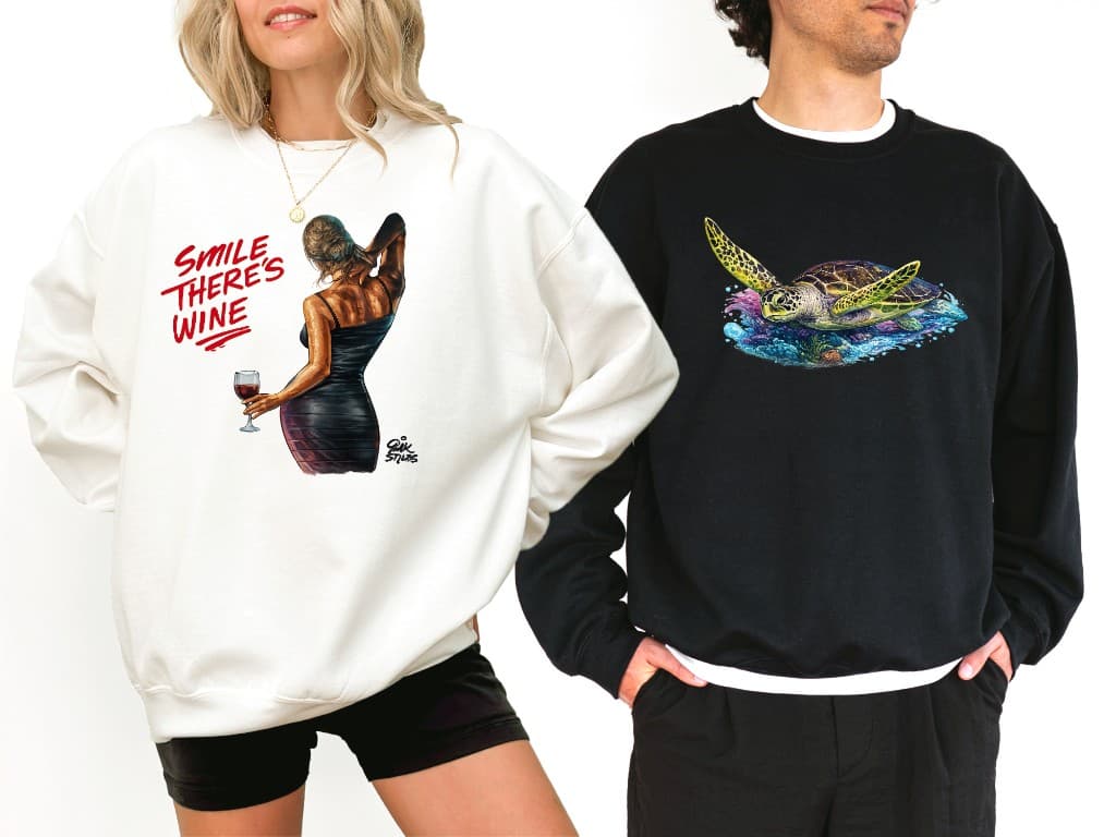 Models wearing sweatshirts featuring Bulk Styles artwork designs including a wine themed illustration and sea turtle by artist Mark Francis