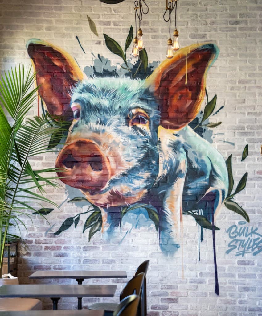 Bulk Styles pig mural on a restaurant wall—example of where licensed artwork is used