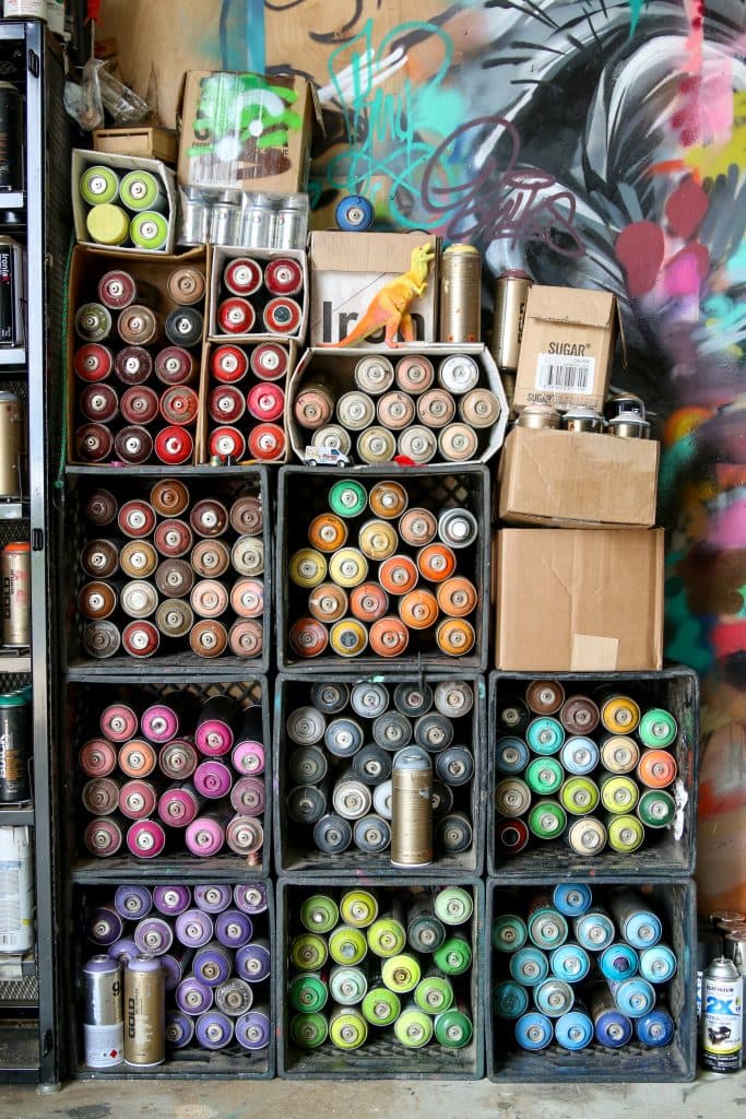 Organized spray paint cans in the Bulk Styles art studio
