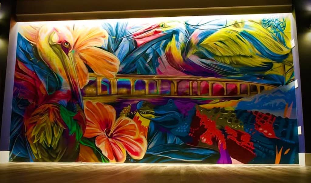 colorful waterfront Stuart mural by mural artist Bulk Styles featuring Florida wildlife and tropical birds