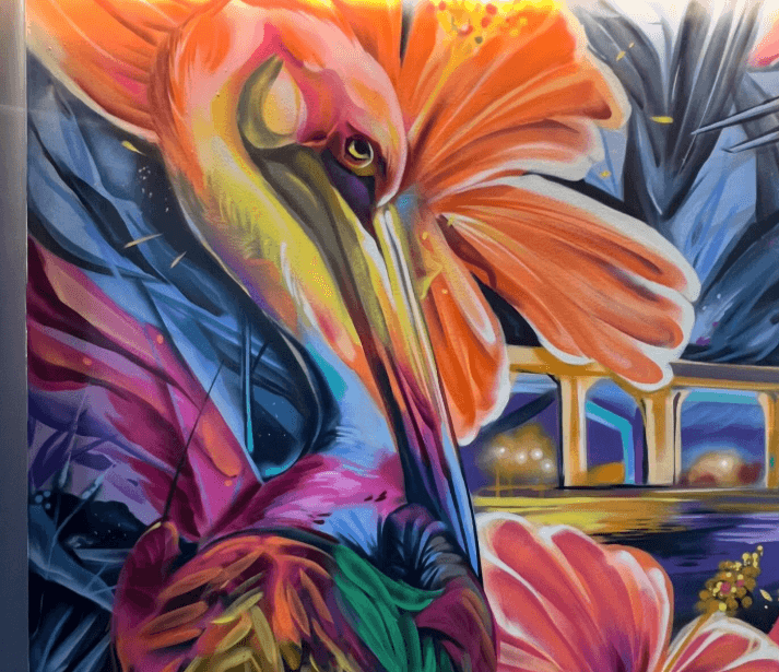 close up of colorful pelican and tropical flowers from the Waterfront Stuart mural by artist Bulk Styles with the Roosevelt Bridge