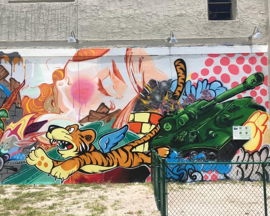 Close up of tiger character and green tank in Clematis Street mural on the Respectable Street building in West Palm Beach by Bulk Styles