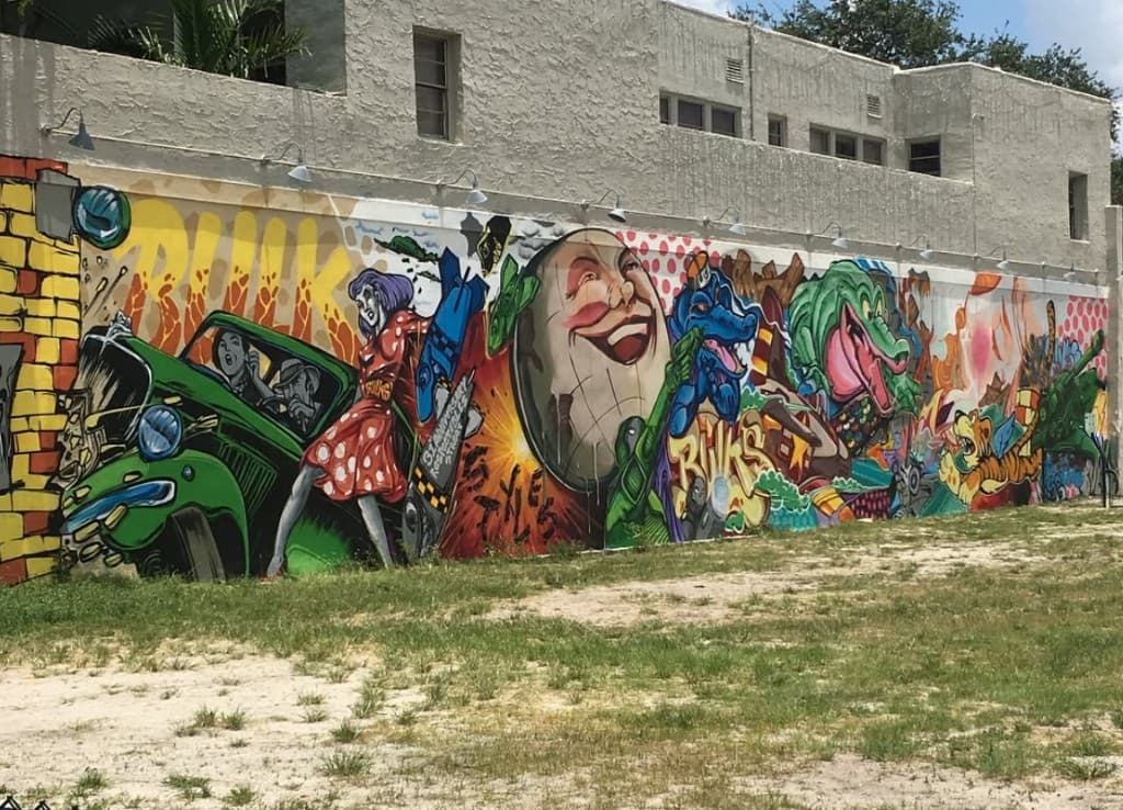 Detailed section of Clematis Street mural on the Respectable Street building featuring colorful characters and graffiti style artwork in West Palm Beach by Bulk Styles
