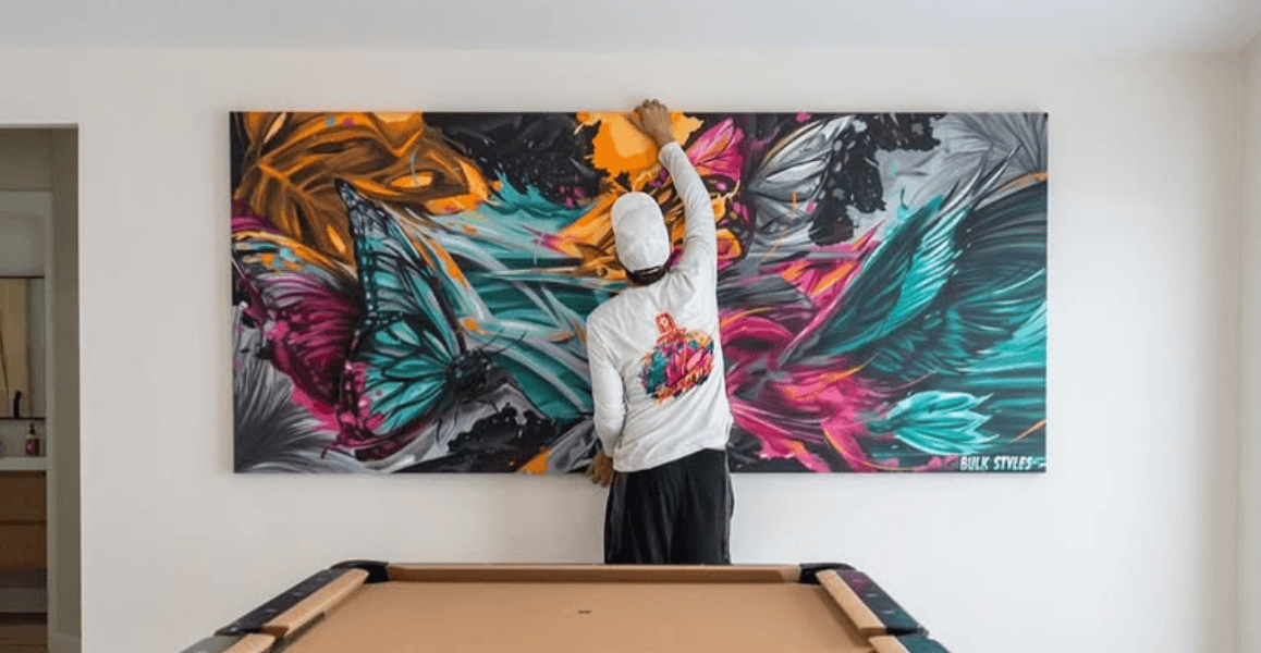 Mark Francis of Bulk Styles installing a large custom butterfly themed artwork commission
