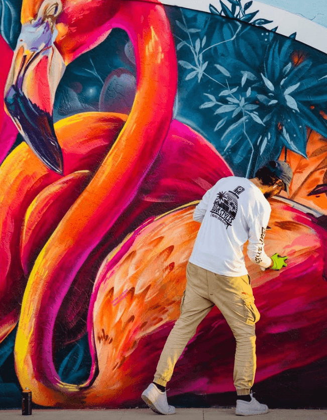 Mark Francis painting flamingo mural