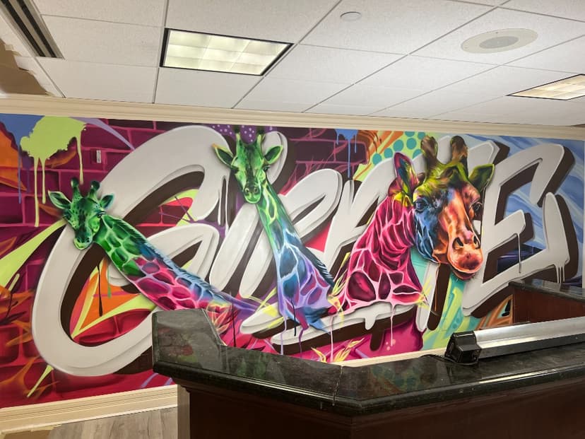 Giraffe Media Group office mural — graffiti-style giraffes by Mark Francis