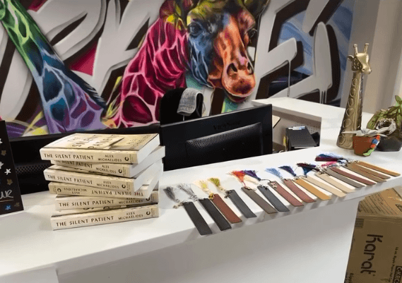 reception desk at Giraffe Media Group office with colorful giraffe mural by Mark Francis Bulk Styles in the background