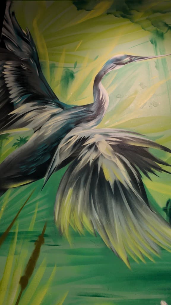 Mack House Brew Pub heron mural detail by Mark Francis, Bulk Styles – wildlife mural with wings spread in wetland setting