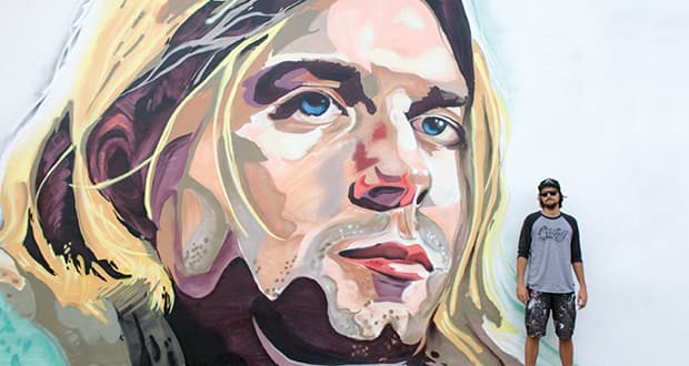 mural artist Mark Francis Bulk Styles standing in front of a large scale mural