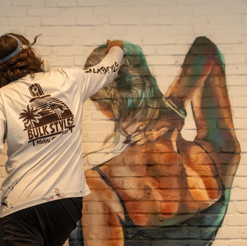 mural artist Mark Francis painting the Lynora's restaurant mural in West Palm Beach Florida