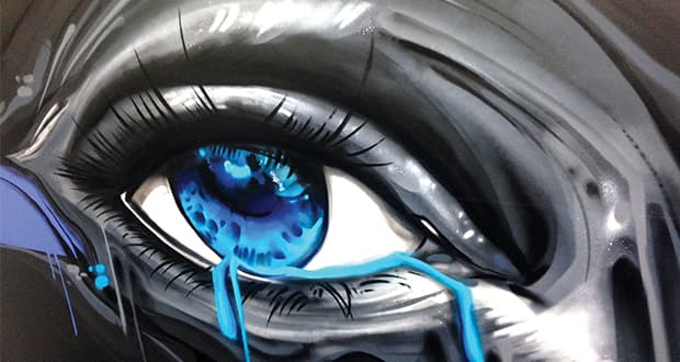 Realistic mural painting of a blue eye with tears created in a contemporary street art style