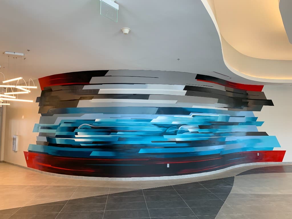 Abstract contemporary commercial mural with layered geometric design inside a modern business interior