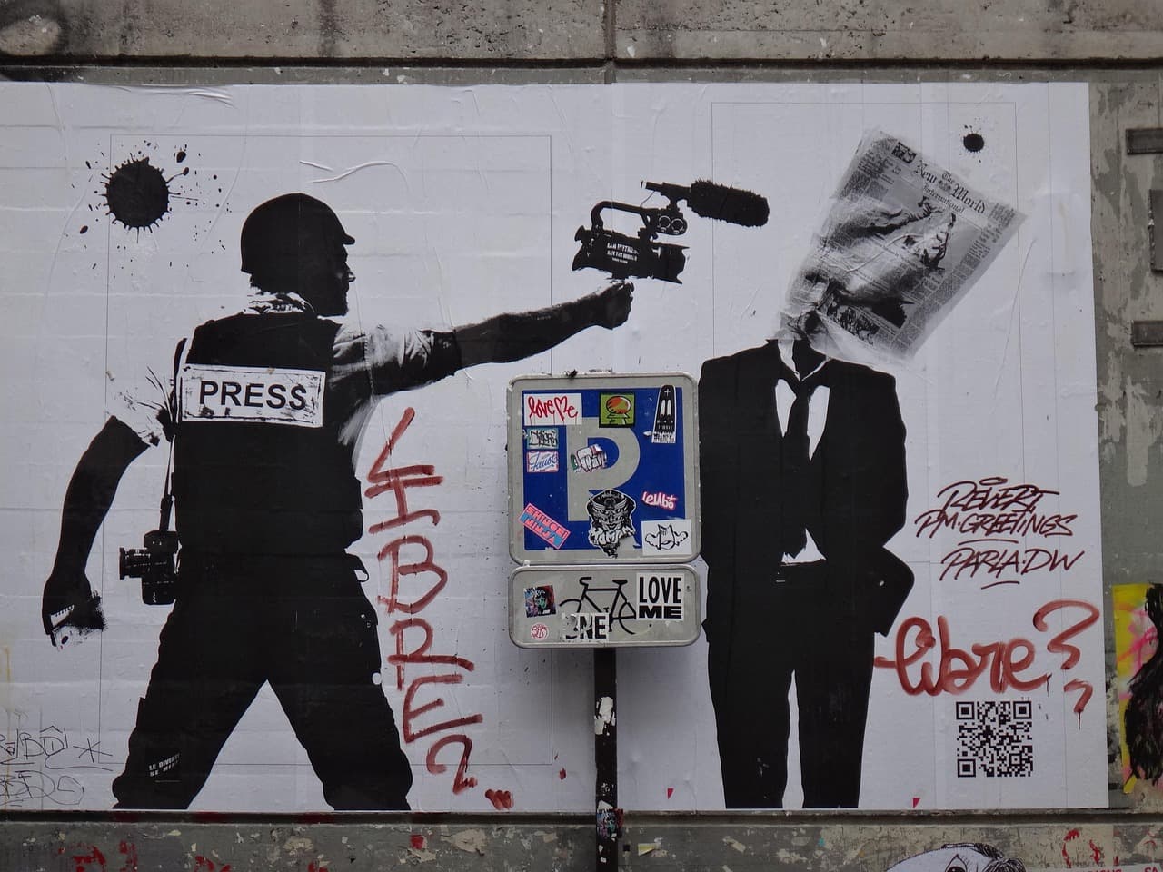 Stencil street art — journalist in PRESS vest and suited figure with newspaper over head, political commentary on media and freedom