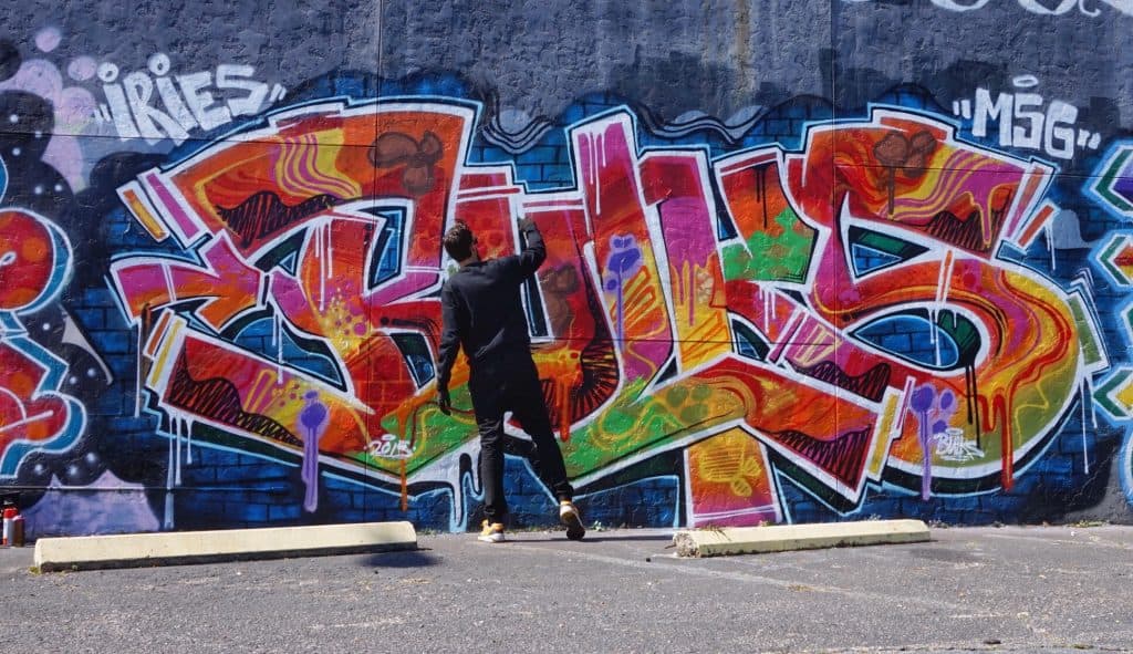 Mark Francis (Bulk Styles) painting a graffiti mural