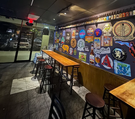 The Mack House Brew & Pub interior — high-top tables, brewery signs and decorated wall in Davie, Florida