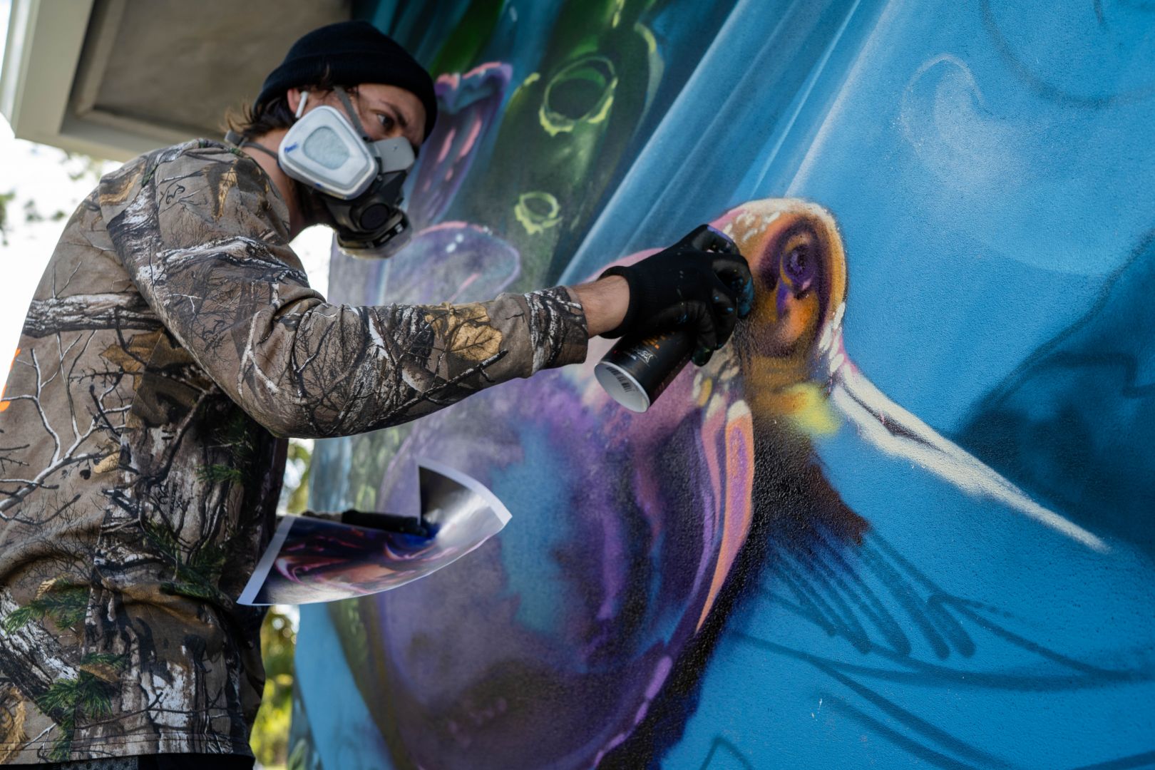 mural artist Mark Francis Bulk Styles spray painting a mural featured in Shoutout Miami interview